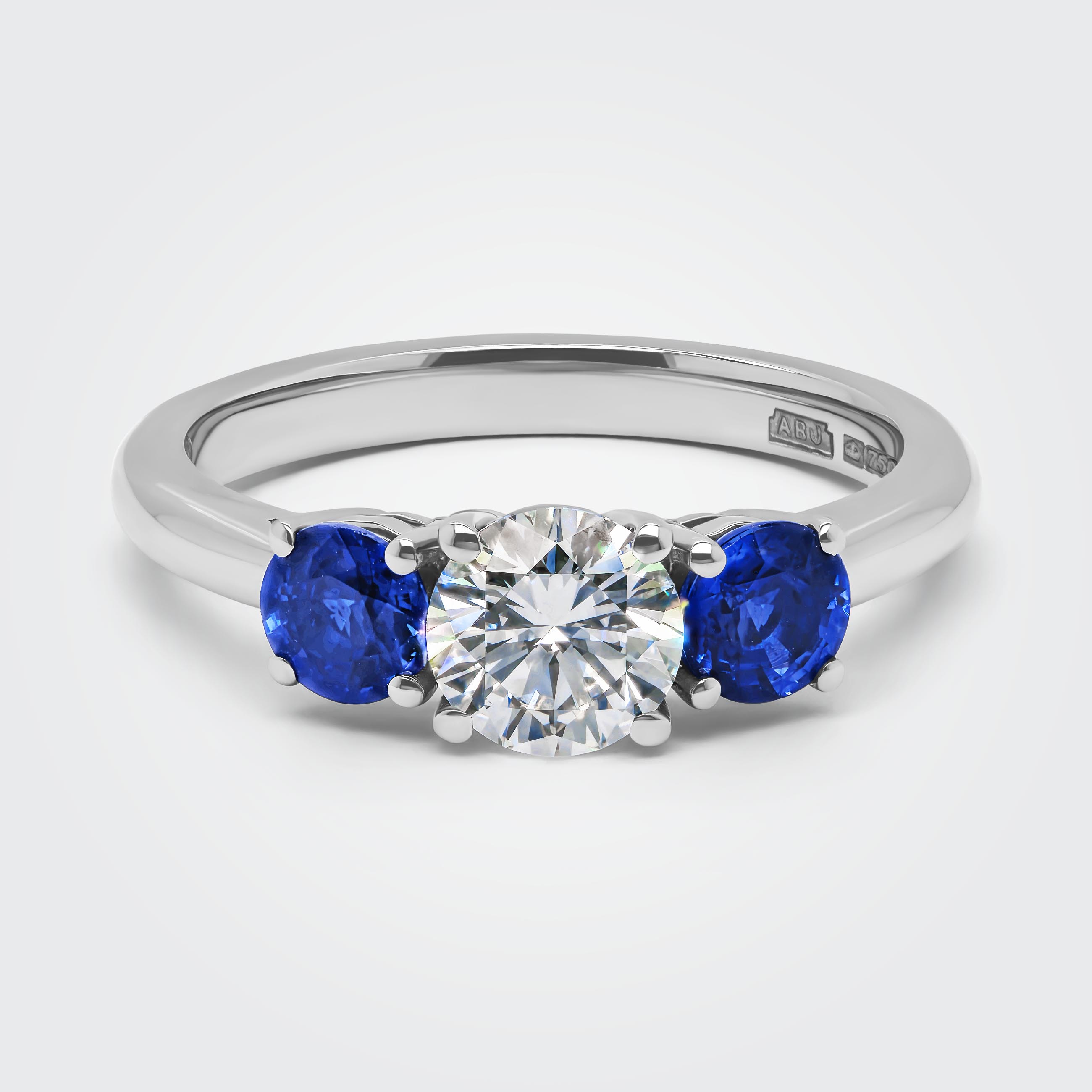 Catrina Brilliant Round Cut Diamond Blue Sapphire Trilogy Engagement Ring