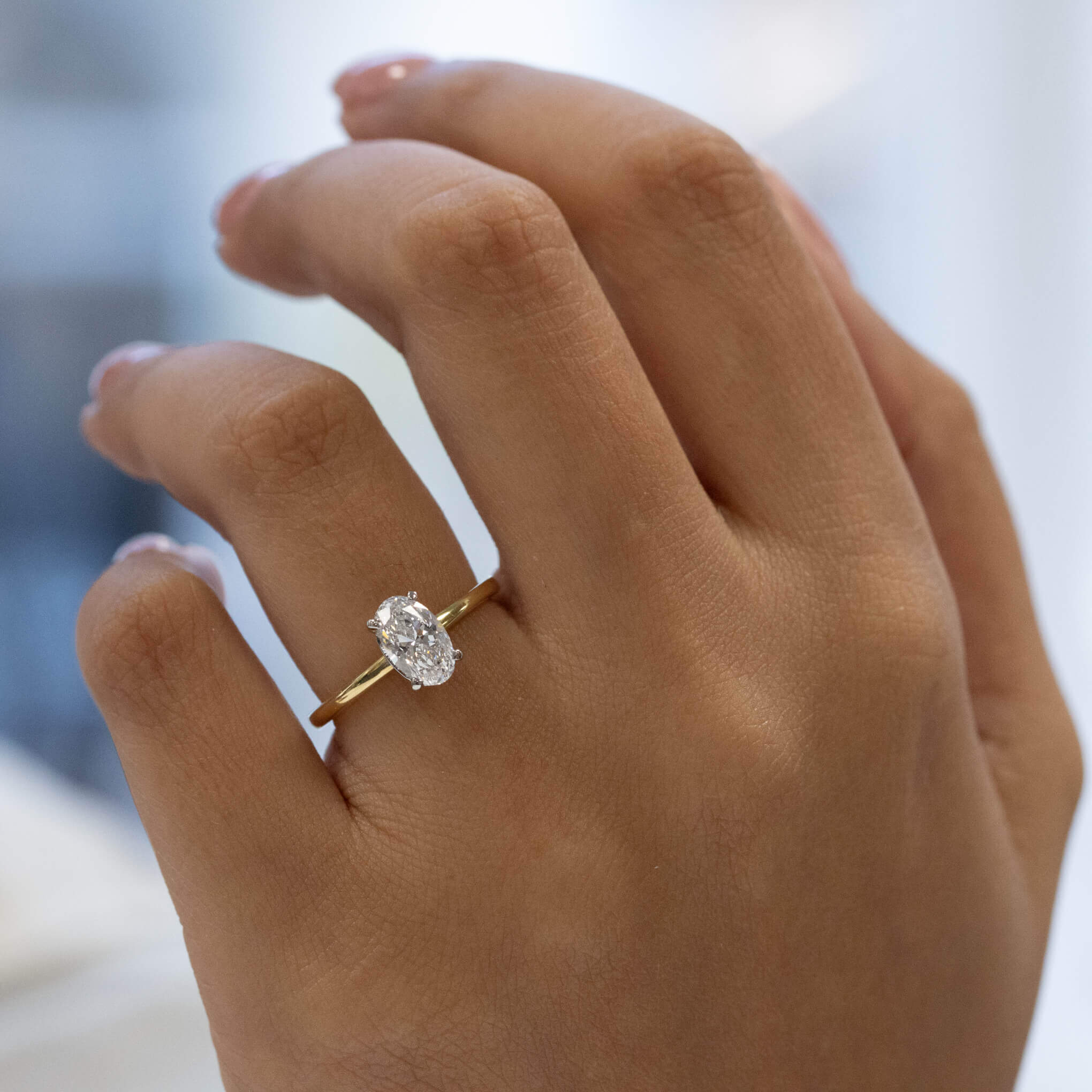 Lea oval diamond hidden halo engagement ring in 18ct yellow gold, Alan Bick